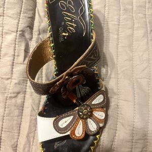 Women’s white & black Elite by Corkey’s hand painted tooled leather sandals.